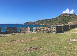 Antigua coastline and outer fort wall with cannon ports as seen from the Fort Berkeley Peninsula in...