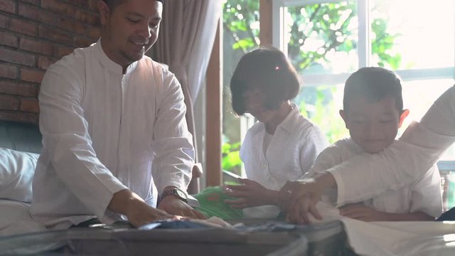 Muslim family prepare clothes and suitcase for carried when mudik go to the village