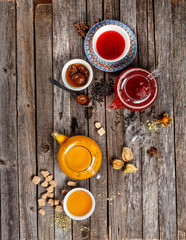 Authentic fruit tea with dried fruit in sweetened syrup. Red and yellow tea table nice presentation with white sugar cubes on a wooden table photography best use for magazine.