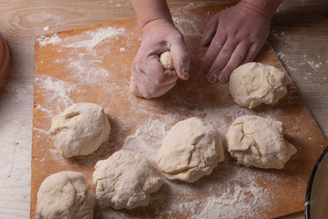 Female hands mixing dough in the home kitchen.