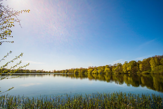 Beautiful, blue and deserted Unisee - a lake in Bremen at sun and blue sky