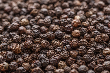 Peppercorn background. Dry black pepper seeds. Top view. Flat design. Macro spice background