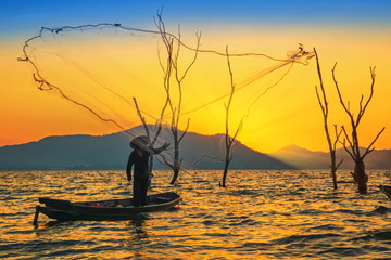 Fishermen on a fishing boat.Fishermen are casting nets.
