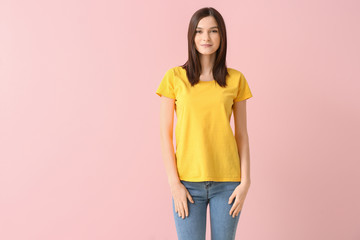 Woman in stylish t-shirt on color background