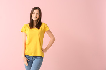 Woman in stylish t-shirt on color background