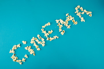 the word “cinema” - laid out with popcorn, popcorn, the concept of leisure and free time, cinema and entertainment, home relaxation