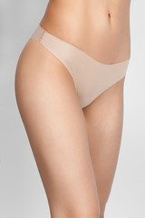 a woman in beige body shorts