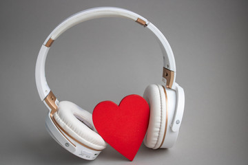 red heart with headphones on gray background. valentines day concept