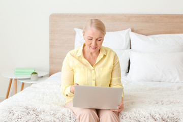 Senior woman video chatting at home