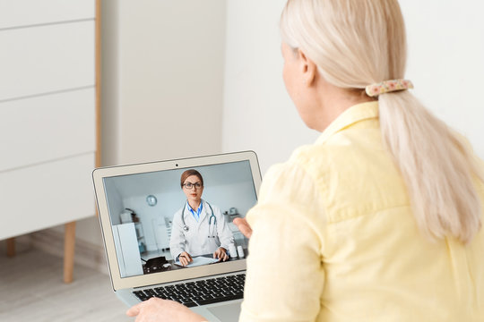 Senior Woman Video Chatting With Doctor At Home