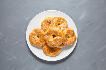 Gluten-free homemade cakes. Curd rings or bagels on a plate. Top view, close-up. Place for text