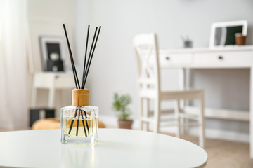 Reed diffuser on table in room