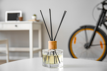 Reed diffuser on table in room