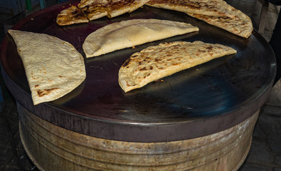 Fototapeta premium corn tortillas cooking on a hot grill in an indigenous Mexican market 