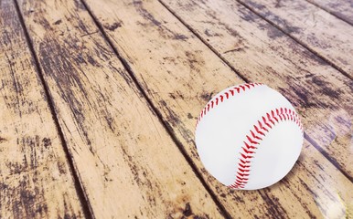 Baseball ball with seams on the wooden desk
