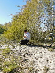 woman cowers in the nature of a beautiful remote scenery while using her mobile