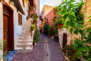 Fototapeta na wymiar Charming streets of Greek islands, Crete. Street in the old town of Chania, Crete, Greece. Beautiful street in Chania, Crete island, Greece. Summer landscape. Travel and vacation.