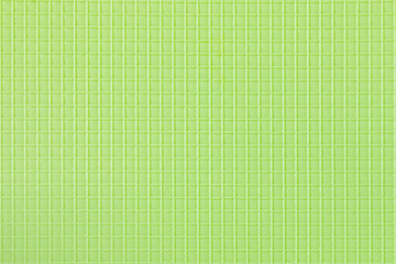 light green plastic background with a repeating square texture.