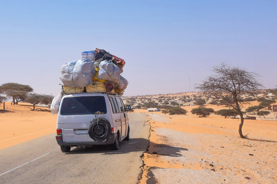 Overloaded Shared Taxi with Luggage as Public Transport Crossing the Mauritanian Sahara Desert
