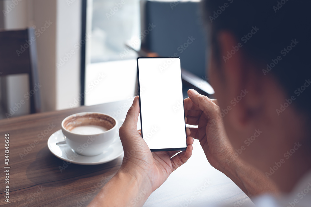 Wall mural Mockup of man using smartphone in cafe