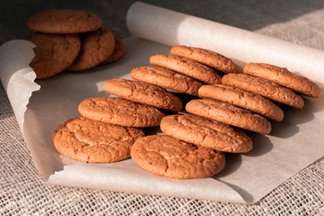 Several groups of crunchy oatmeal homemade cookies on sacking background