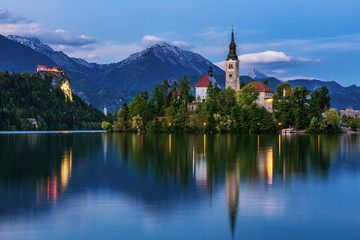 Fototapeta na wymiar Lake Bled Slovenia. Beautiful mountain lake with small Pilgrimage Church. Most famous Slovenian lake and island Bled with Pilgrimage Church of the Assumption of Maria. Bled, Slovenia, Europe.