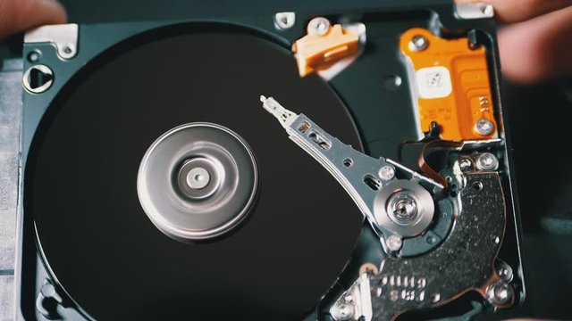 Opened Hard Disk Drive with Spinning Platter. Move of Magnetic Head. Slow Motion