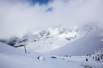 Sunset in Kasprowy wierch in Polish Tatra Mountains in winter snow weather conditions Kasprowy wierch High Tatras. Panoramic winter view of west Tatra mountain.