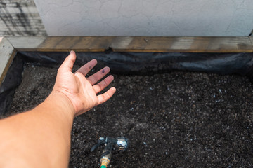 Hand carrying a hose to irrigate