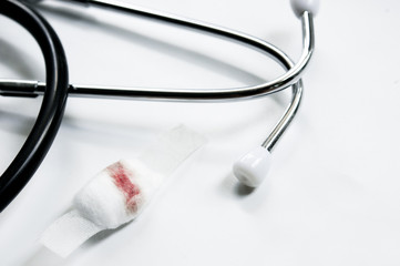 Blood on cotton wool and white plaster on white background with Stethoscope. Blood Donation...