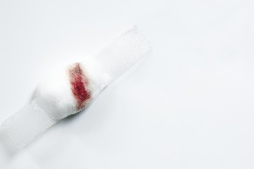Blurred blood on cotton wool and white plaster on white background. Blood Donation on white...