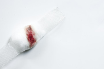 Blurred blood on cotton wool and white plaster on white background. Blood Donation on white background. Morphology vaccines concept.