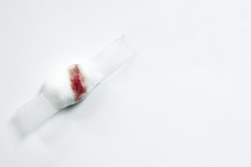 Blurred blood on cotton wool and white plaster on white background. Blood Donation on white...