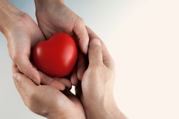 Woman and man hand holding red heart, health care, donate and family insurance concept, world heart day, world health day,CSR responsibility, adoption foster family, hope, gratitude, kind, concept