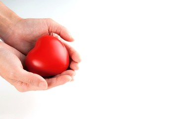 Woman hand holding red heart, health care, donate and family insurance concept, world heart day, world health day,CSR responsibility, adoption foster family, hope, gratitude, kind, concept