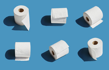 White toilet paper roll on blue background with shadow
