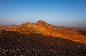 Panoramic view at volcanic landscape nearby Pajara on canary island Fuerteventura. Sunset in october 2019