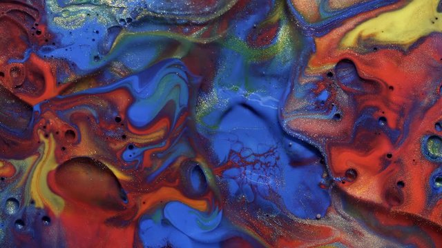 Colorful Blue Red And Yellow Paint Spreading On Universe Colors Surface Mix In Fantastic Design And Patterns. Gold Dust Sparkling Particles, Ink Drops And Mixing. Multicolored Background In Motion