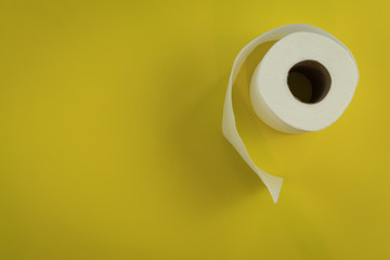 Toilet paper yellow copy space flat lay