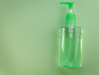 Hand Sanitizer pump no label green opy space flat lay