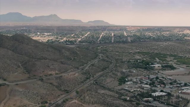 Aerial: El Paso border wall for Mexico & USA and train tracks