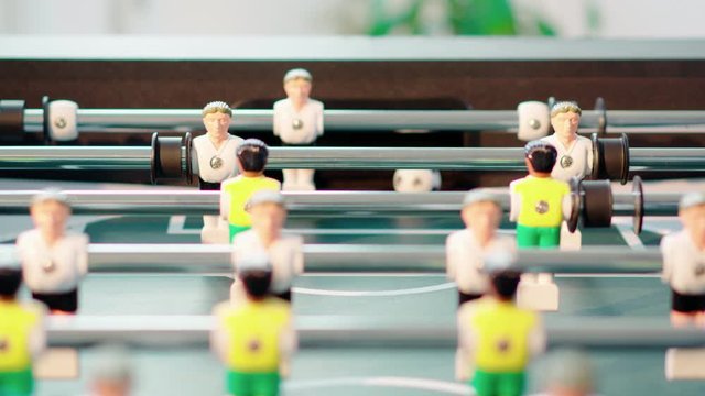 Close up of table soccer game miniatur football germany white player get goal shot in 4k super slow motion