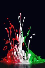 Explosion of multicolored paint caused by sound, on black background