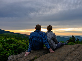 Couple Looks Out Over Sunset Falling on Blue Ridge