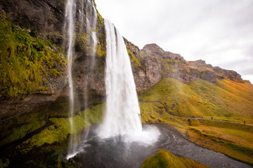 Seljalandsfoss is one of the best-known waterfalls in Iceland that has a path leads you behind the waterfall