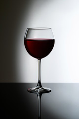 glass of red wine on gradient background