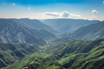Fototapeta premium misty mountain range covered with white mist and amazing blue sky