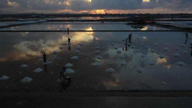 People working on Hon Khoi salt field, Khanh Hoa, Vietna. The raw white salt field on a sunny day. Free stock video footage of white salt field in a beach village. Salt is an important food for people