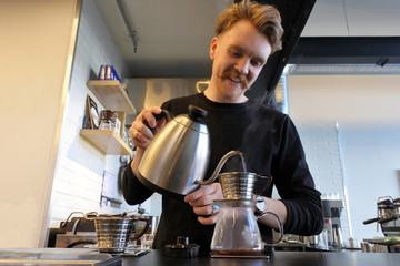 Barista preparing coffee in a cafe