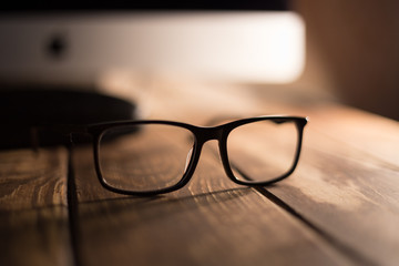 Glasses for sight and vision correction and protection from computer on the wooden table